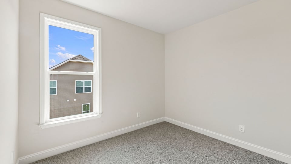 Bedroom with carpet and window.