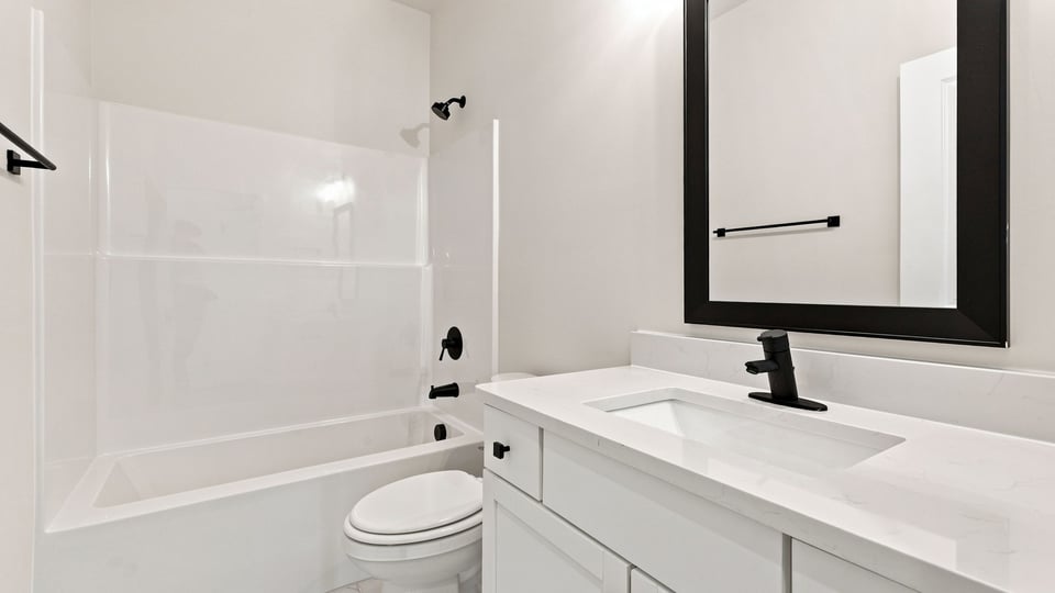 Bathroom with single vanity sink and bathtub.
