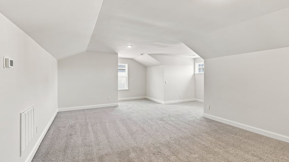 Bedroom with carpet and window.