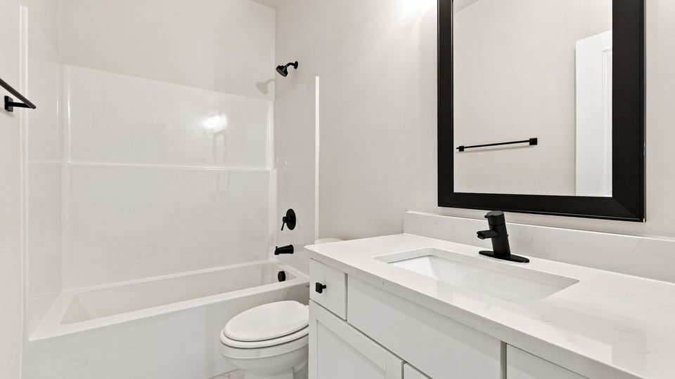 Bathroom with single vanity sink and bathtub.