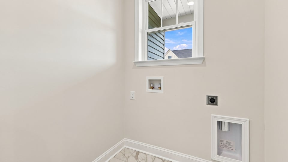 Laundry room with hanging storage racks.