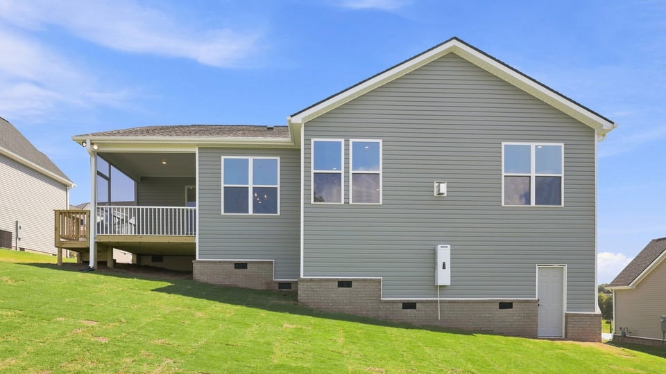 Back exterior of home with large backyard.