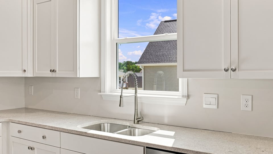 Kitchen and island with quartz countertops.