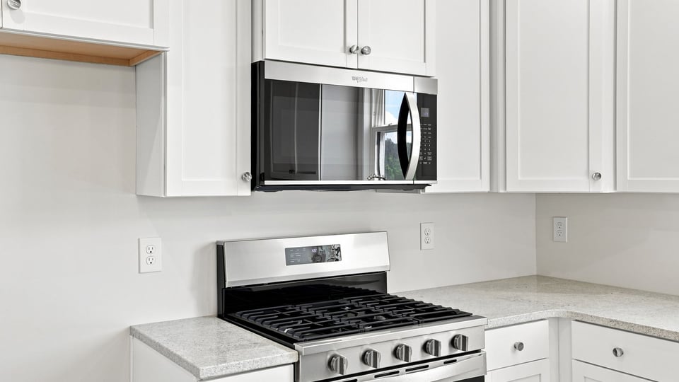 Kitchen and island with quartz countertops.