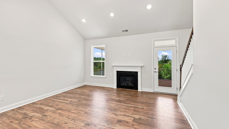 Living room with windows and fireplace.