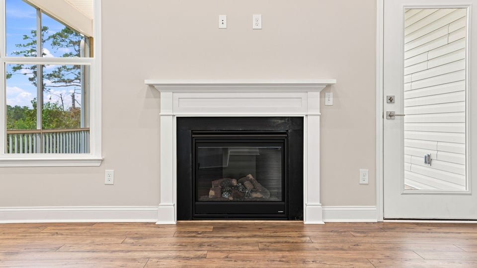 Living room with windows and fireplace.