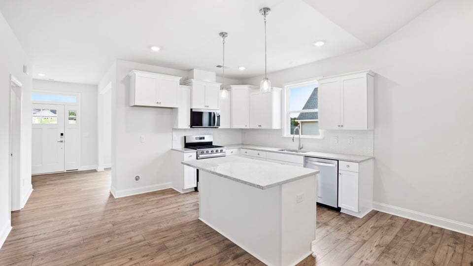 Kitchen with island and cabinets.