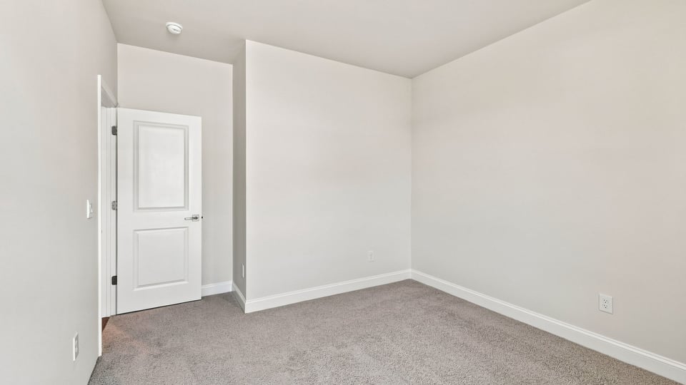 Bedroom with carpet and window.
