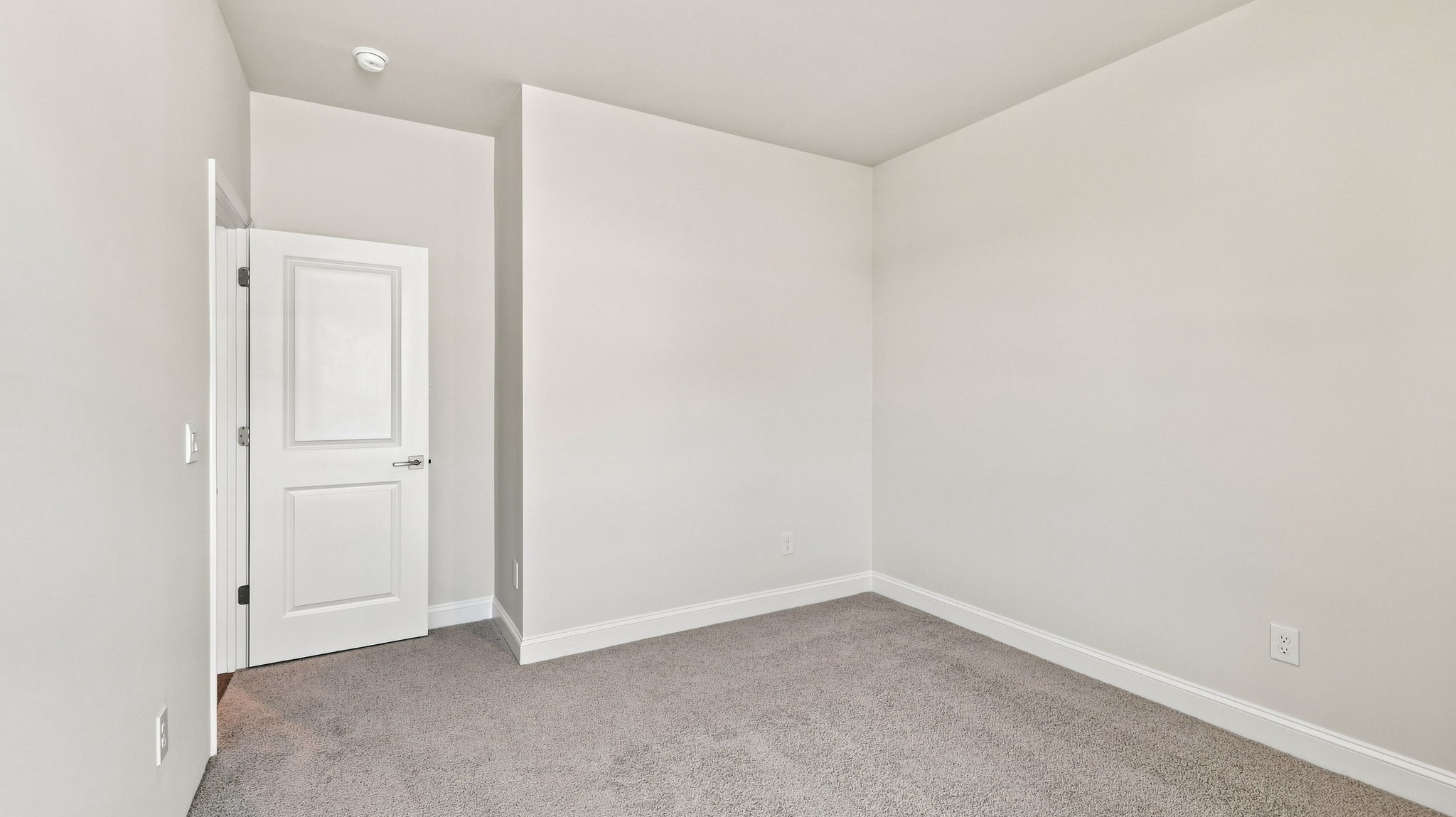 Bedroom with carpet and windows.