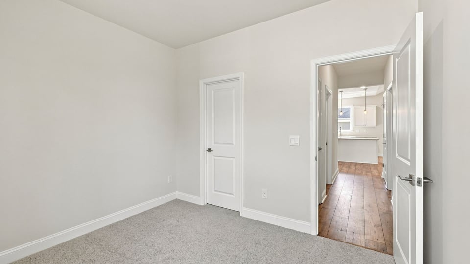 Bedroom with carpet and window.