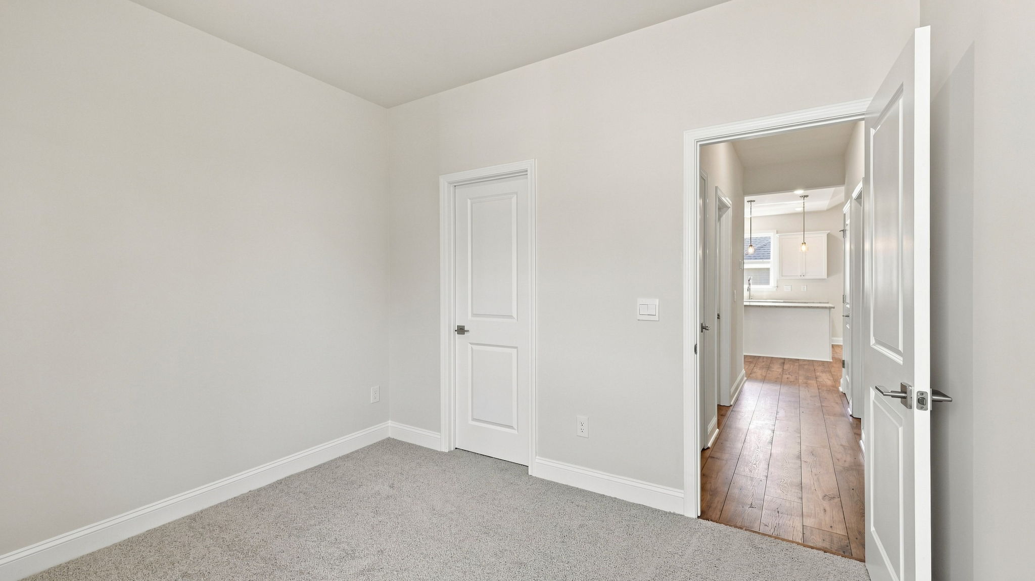 Bedroom with carpet and windows.