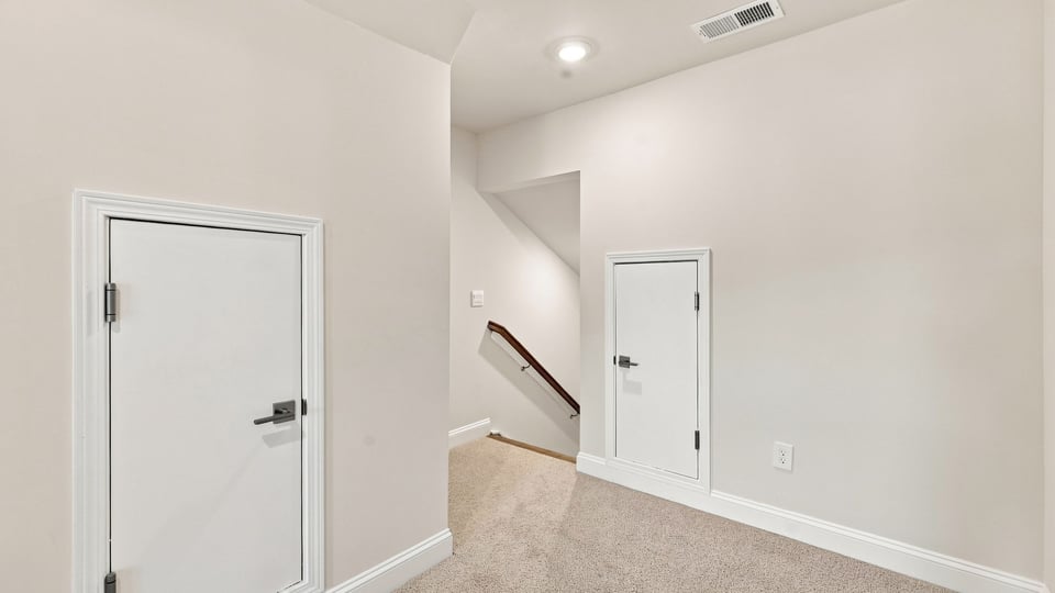 Bedroom with carpet and window.a