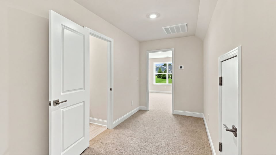 Bedroom with carpet and window.