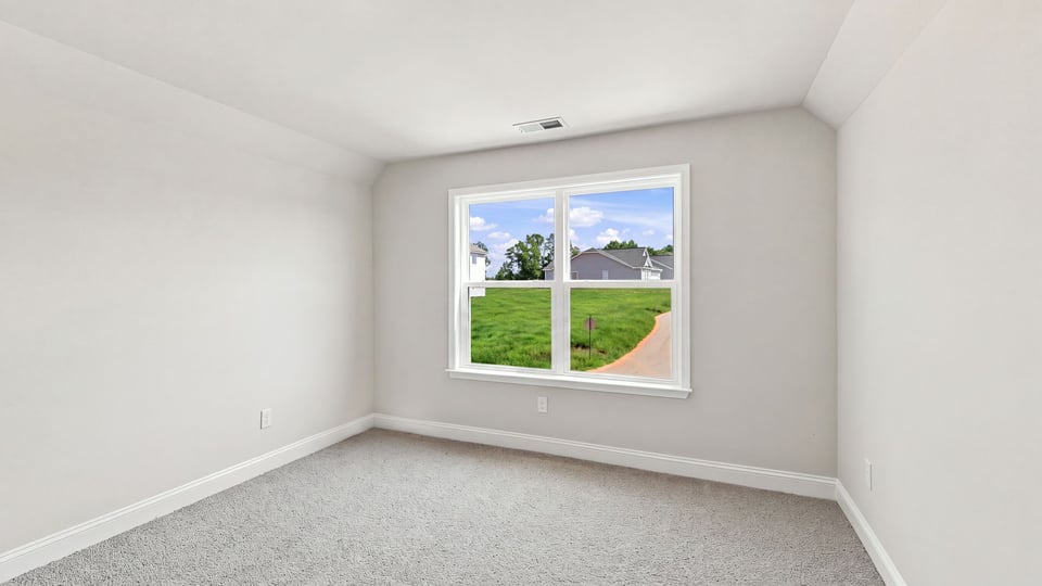 Bedroom with carpet and window.