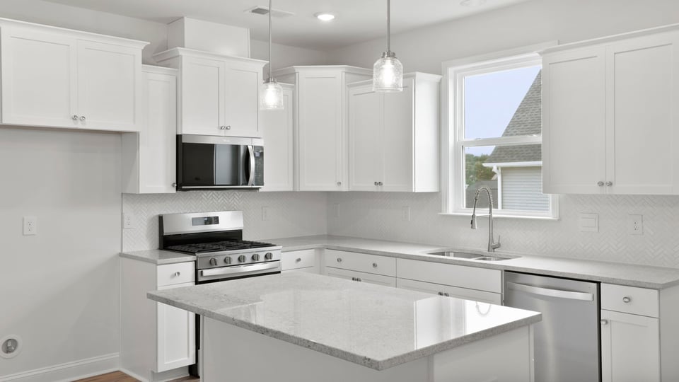 Kitchen with island and cabinets.