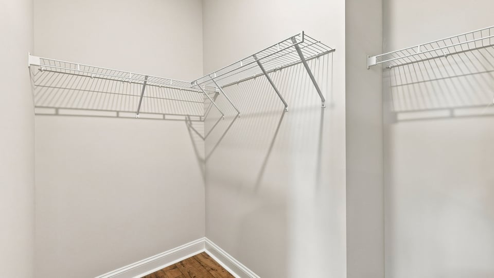 Closet with hanging storage racks.