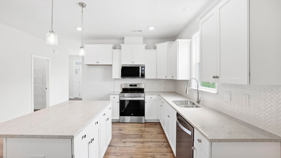 Kitchen with island and cabinets.