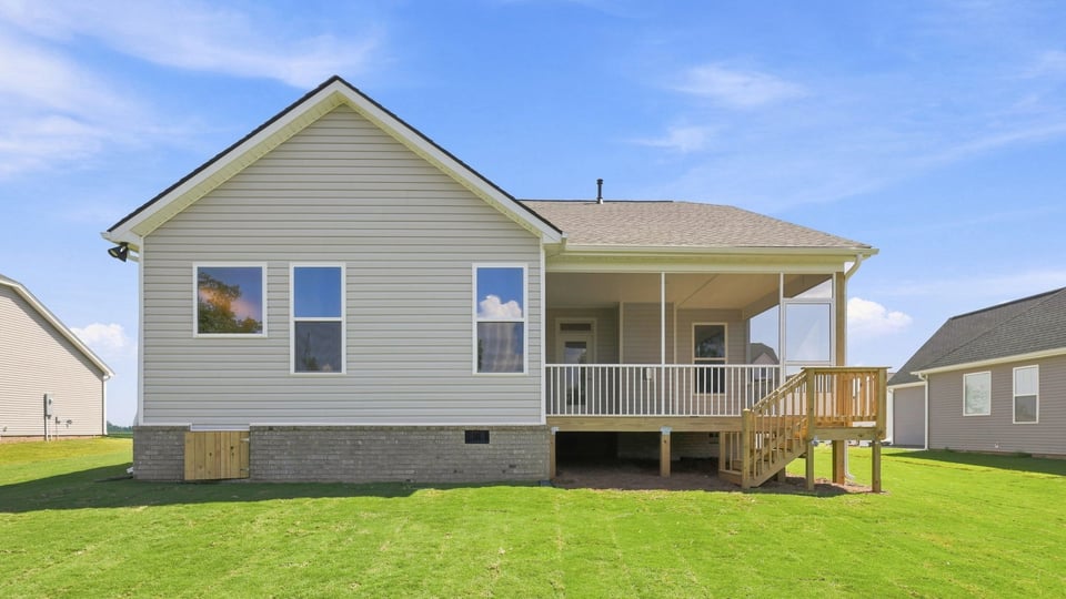 Back exterior of home with large backyard.
