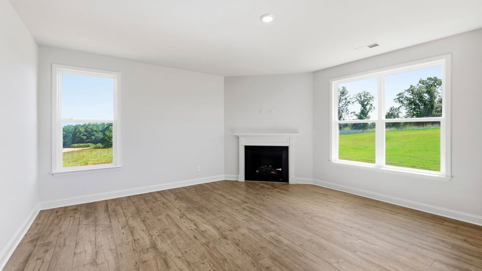 Living room with windows and fireplace.