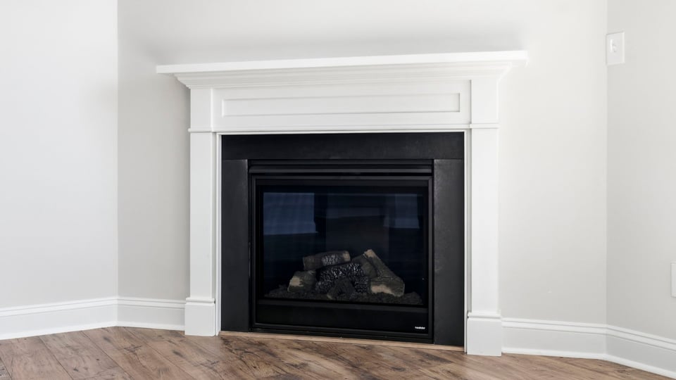 Living room with windows and fireplace.