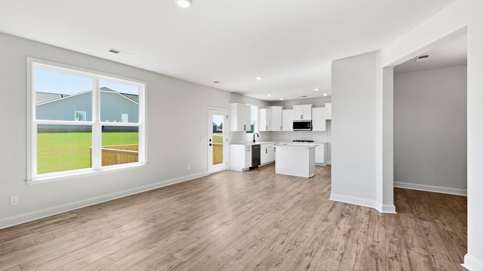 Kitchen and island with quartz countertops and stainless steel appliances.