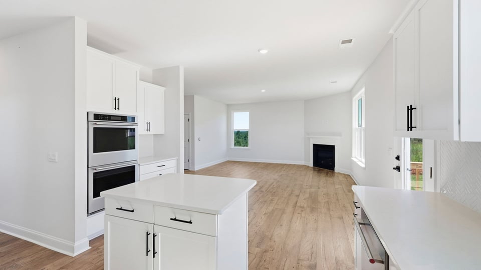 Kitchen and island with quartz countertops and stainless steel appliances.