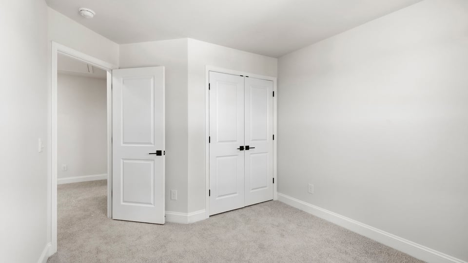 Bedroom with carpet and window.