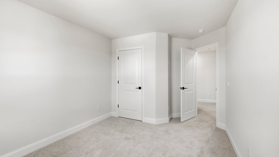 Bedroom with carpet and window.