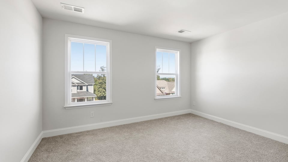 Bedroom with carpet and window.