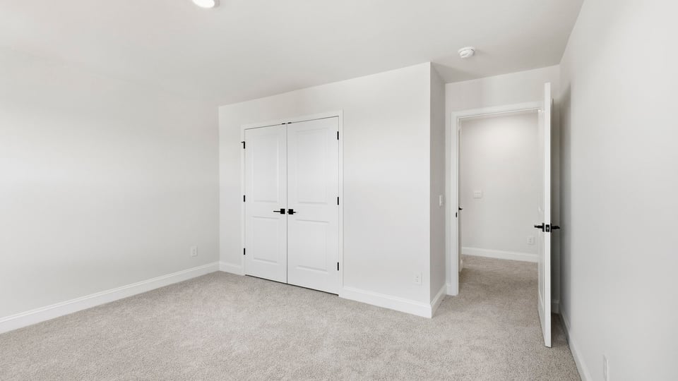 Bedroom with carpet and window.