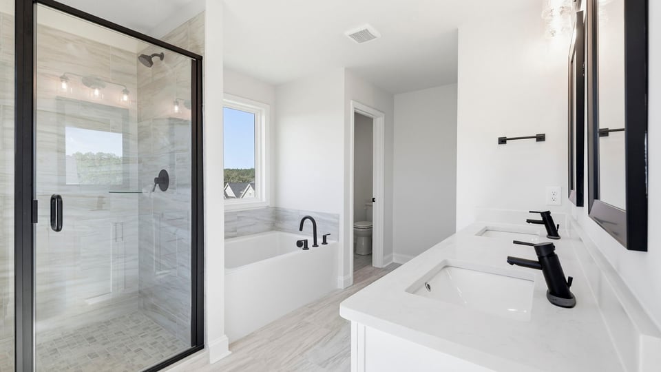 Bathroom with walk in shower and bathtub.