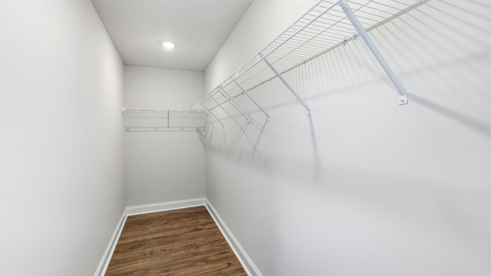 Closet with hanging storage racks.