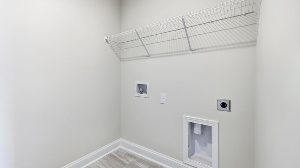 Laundry room with hanging storage racks.