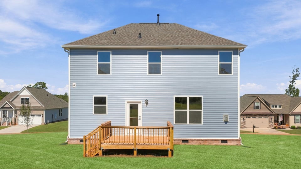 Back exterior of home with large backyard.