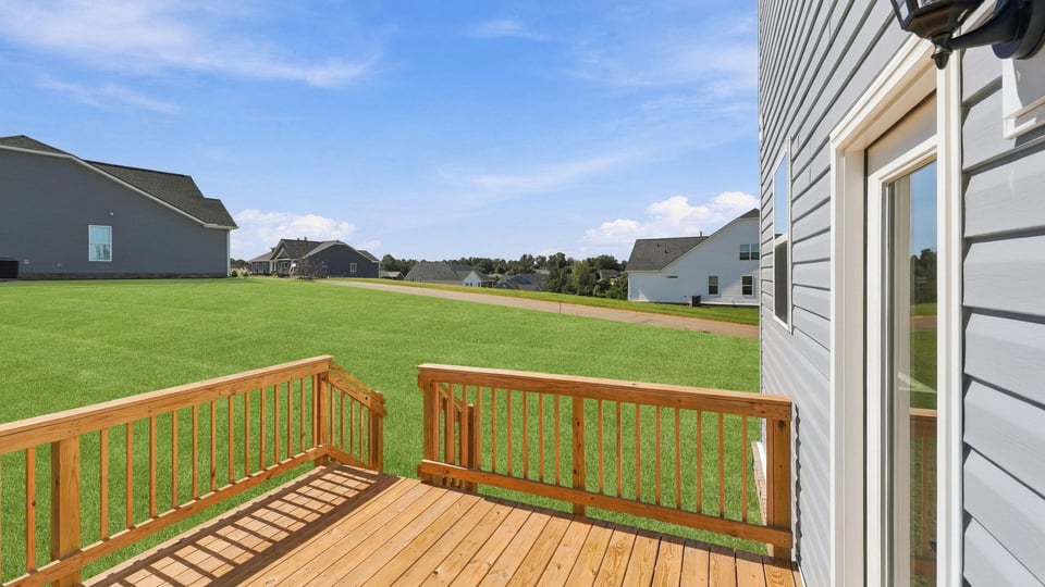 Back exterior of home with small patio.