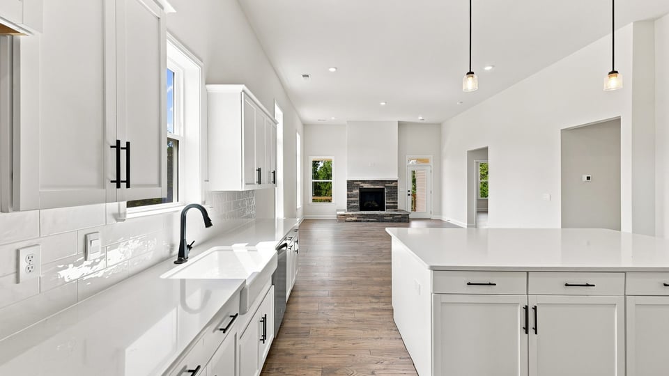 Kitchen and island with quartz countertops.