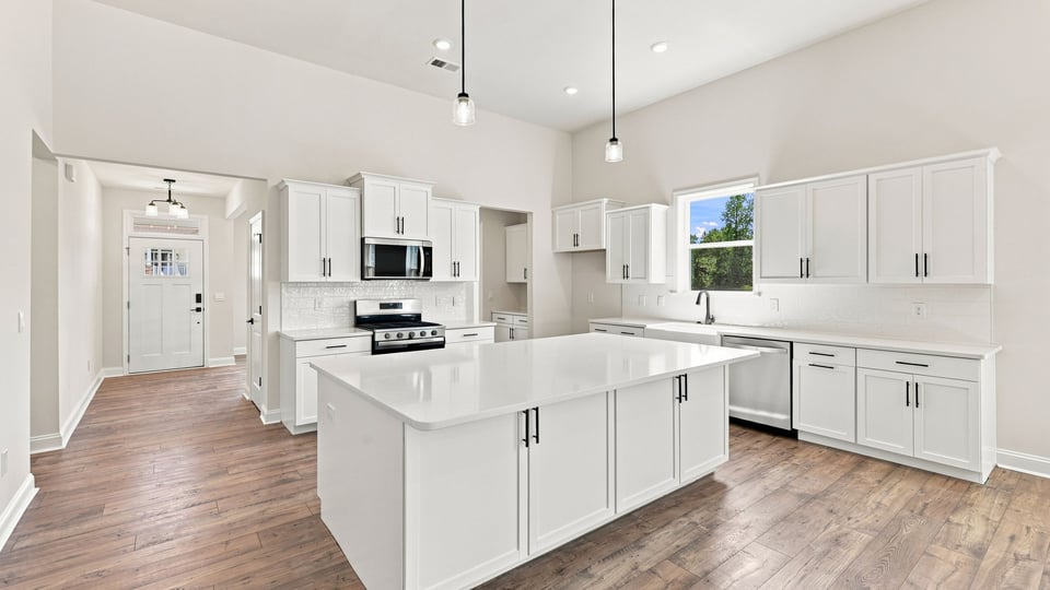 Kitchen and island with quartz countertops.