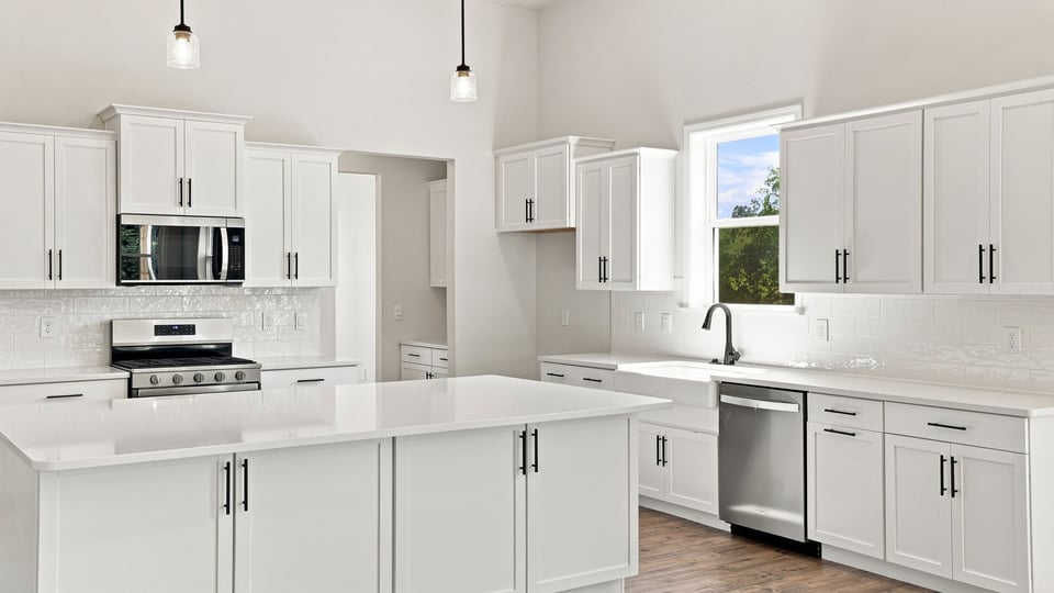 Kitchen and island with quartz countertops.