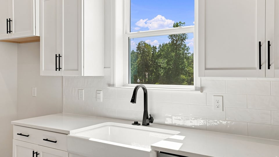 Kitchen and island with quartz countertops.