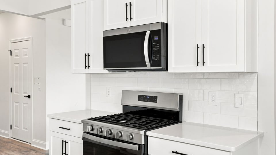 Kitchen and island with quartz countertops.