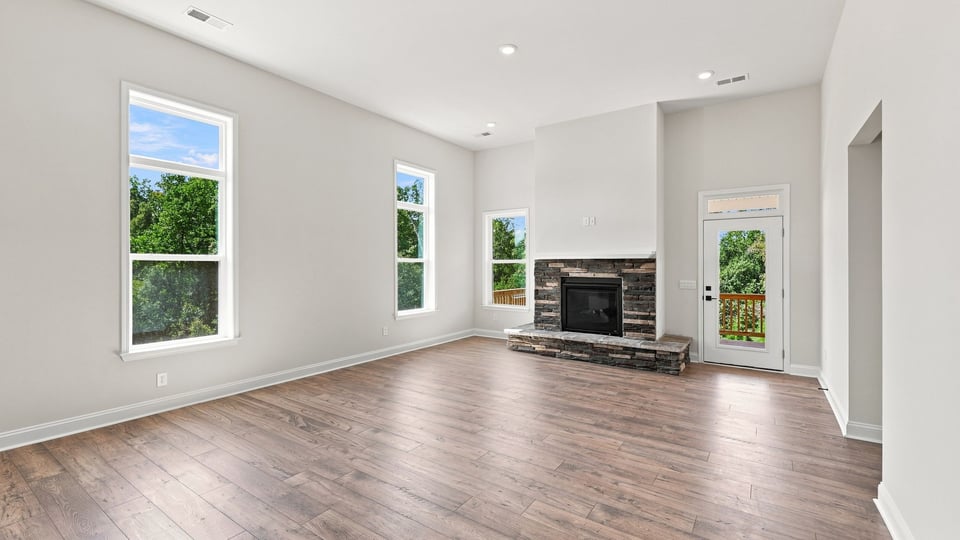 Living room with windows and fireplace.