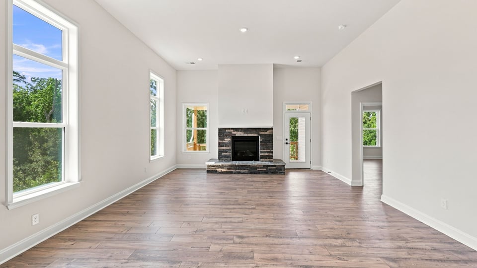 Living room with windows and fireplace.