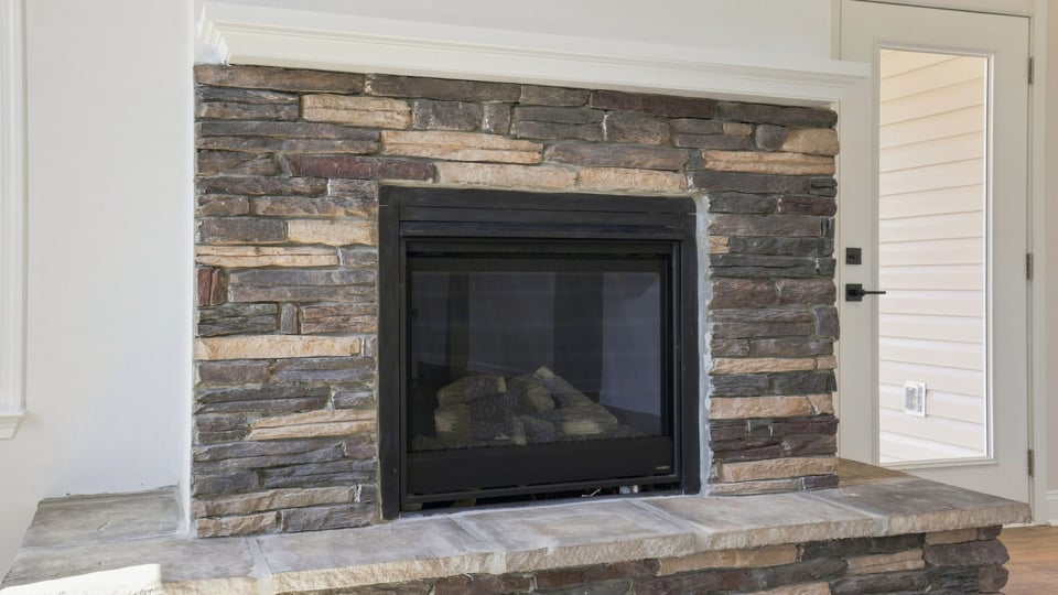 Living room with windows and fireplace.
