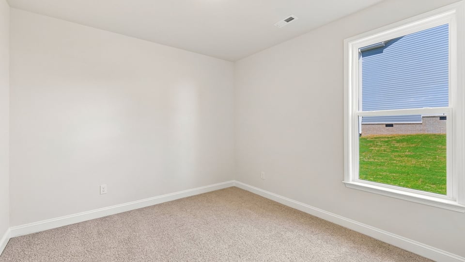 Bedroom with carpet and window.