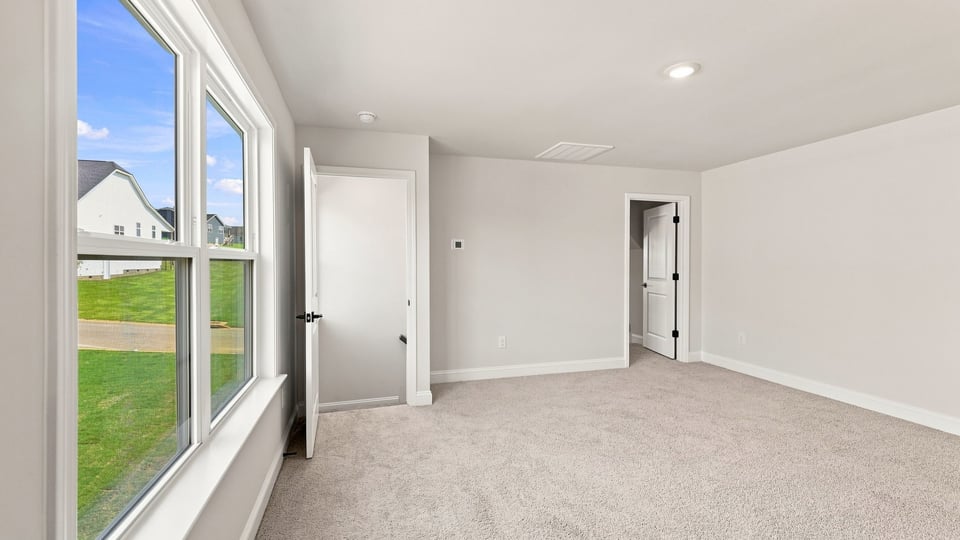 Bedroom with carpet and window.