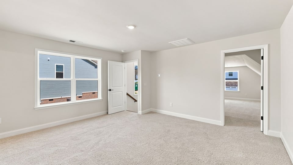 Bedroom with carpet and window.