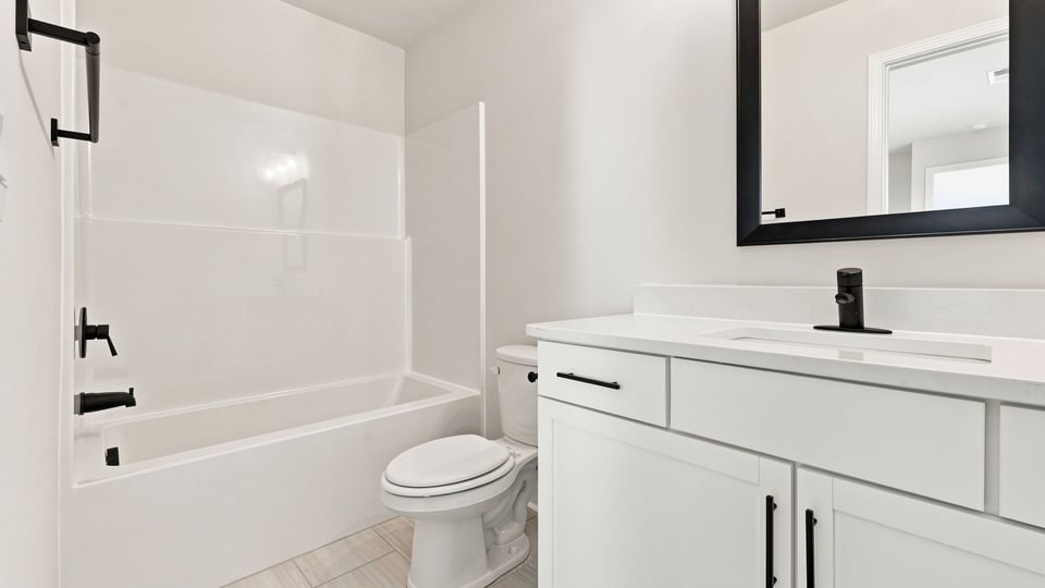 Bathroom with double vanity sink and bathtub.