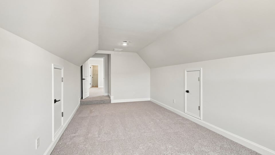 Loft area with carpet and window.