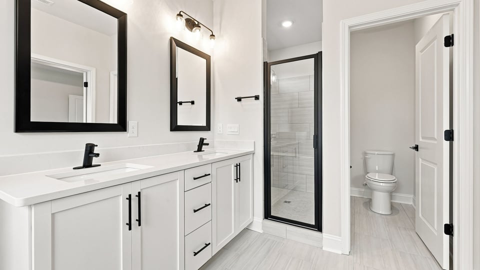 Bathroom with double vanity sink and bathtub.