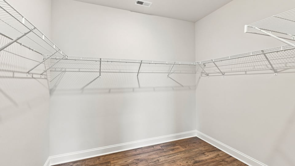 Closet with hanging storage racks.